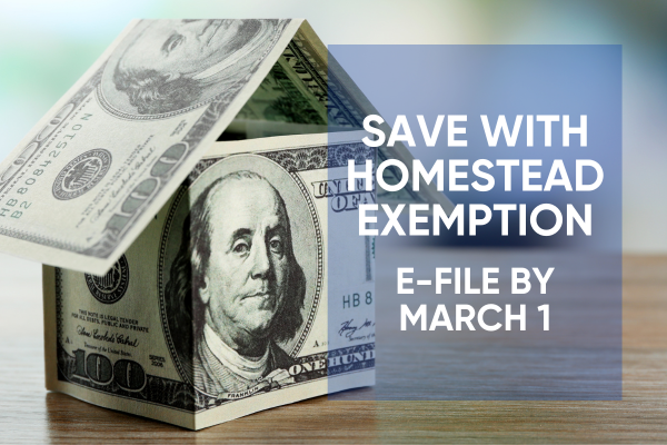 2 people holding a model of a house